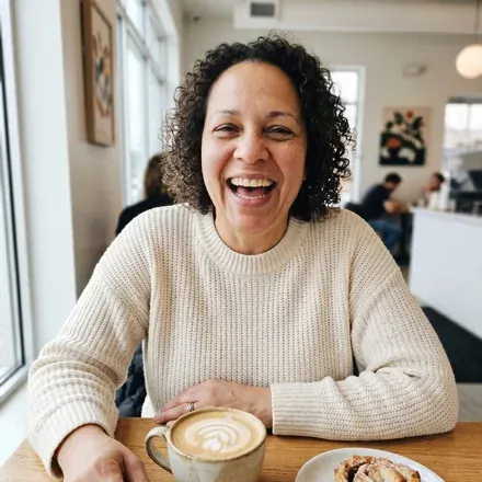 A woman sitting in a cafe with a coffee